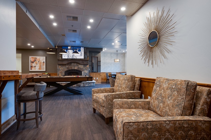 Unwind in this inviting lounge with plush seating, a cozy fireplace, and entertainment options—your perfect spot to relax after exploring.