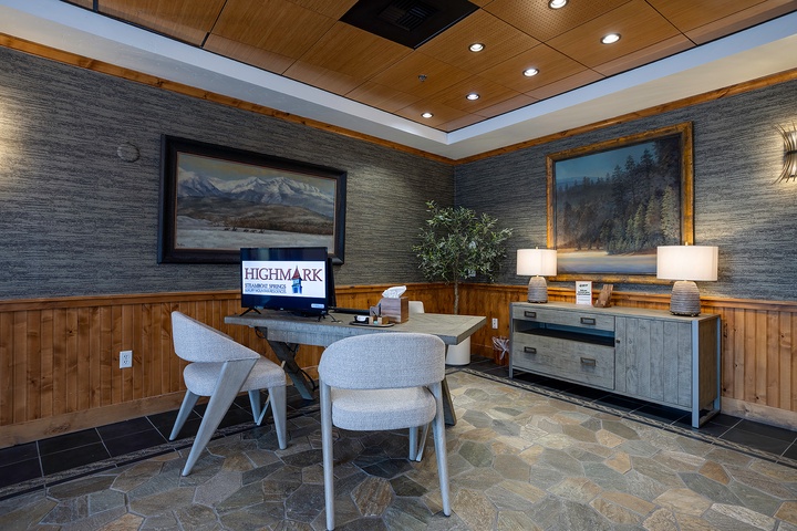 The lobby greets you with warm wood accents, mountain landscapes, and a welcoming desk where your vacation begins. Relax in modern seating as you arrive to your mountain retreat.