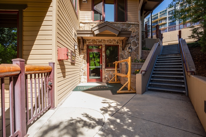Welcoming stone and wood-accented entrance with accessible pathways and convenient access to the surrounding mountain community.