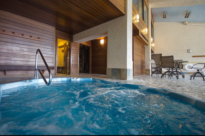 Slip into your private hot tub and let the warm, bubbling water melt away tension while you relax in this inviting spa-like setting.
