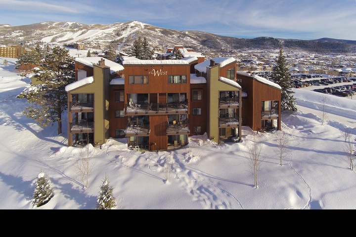 Aerial view of the property nestled in snow-covered mountain terrain, showcasing its prime location near winter recreation areas and scenic landscapes.