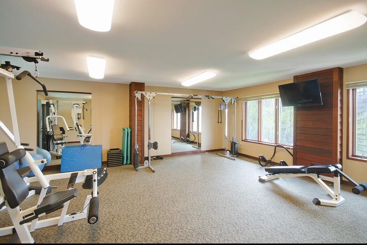 Stay active in your well-equipped fitness center, featuring cardio machines, strength training equipment, and a mounted TV to keep you motivated during your workout.