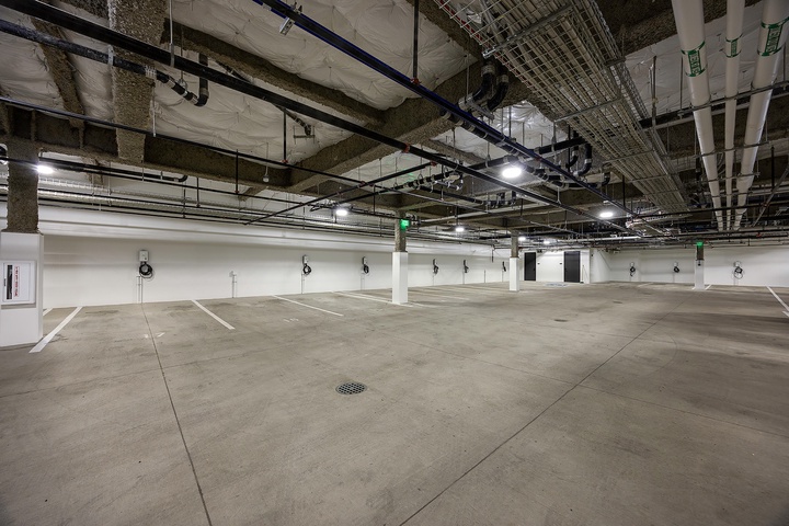 A spacious underground parking garage with marked spaces and modern infrastructure ensures convenient vehicle storage during your stay.