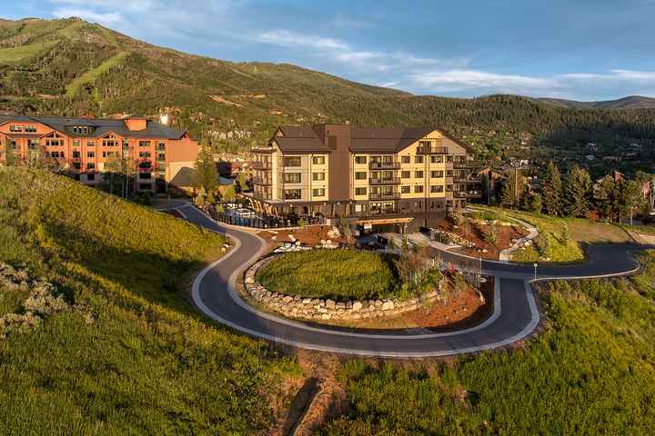 Nestled at the base of a forested mountain range, this alpine resort offers a scenic arrival through landscaped roundabout gardens with peak views in every direction.