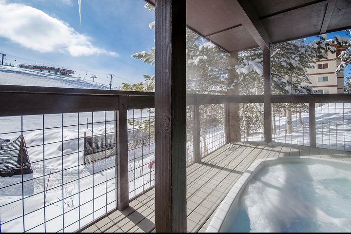 Snowy mountain views surround this private hot tub on your covered balcony—perfect for soaking after a day on the slopes. Sip something warm and watch icicles catch the sunlight overhead.