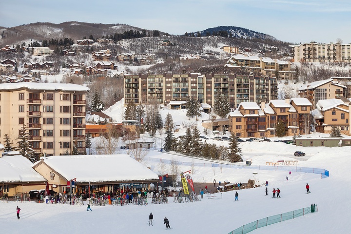 A vibrant ski resort village nestled in snow-covered mountains, offering winter vacation accommodations and direct access to slopes and alpine activities.