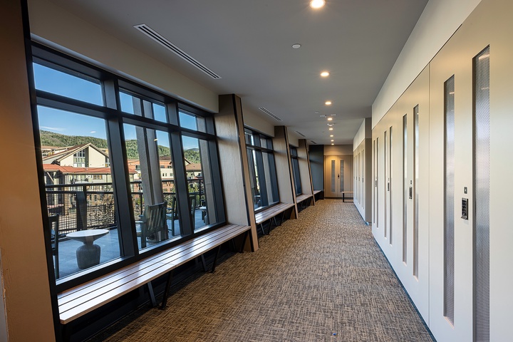 Your home base features a bright corridor with scenic mountain views through floor-to-ceiling windows, plus convenient elevator access to whisk you to your room. Inviting window benches let you linger and soak in the hillside surroundings.