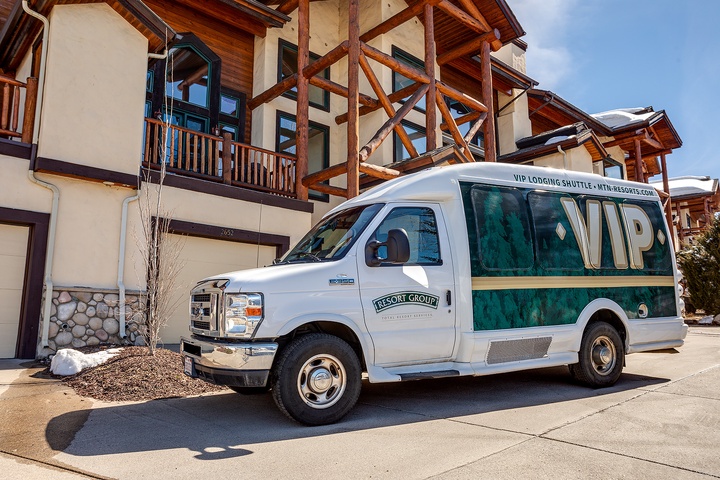 VIP shuttle service awaits at this alpine-style property entrance, offering seamless transportation to nearby mountain attractions and amenities during your winter getaway.