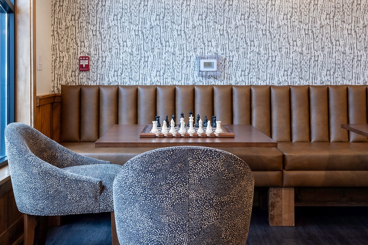 Settle into plush seating where you can strategize over a game of chess, surrounded by warm textures and modern design that invite relaxation.