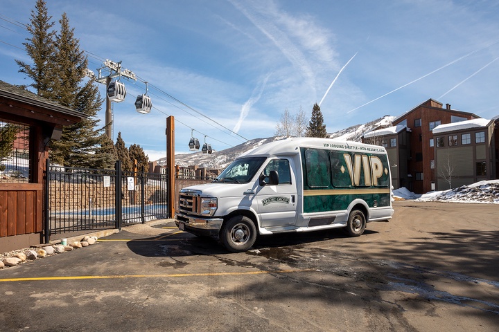 VIP shuttle service positioned near the gondola base, providing convenient transportation to the ski area and surrounding mountain facilities during winter season.