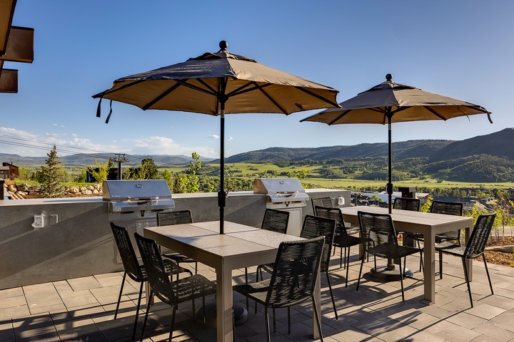 An expansive patio with built-in grills and mountain valley views creates an ideal setting for your outdoor gatherings and al fresco dining under the sun.