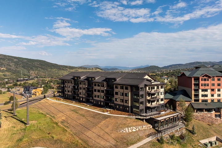 Mountain resort property nestled in a scenic valley, surrounded by rolling hills and dramatic peaks. The multi-building complex offers easy access to natural beauty and outdoor adventure.