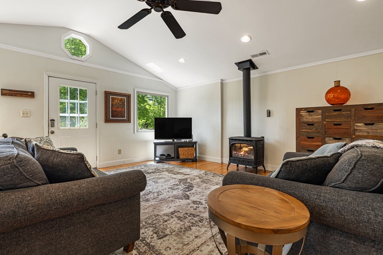 Living Area w/ Wood Stove & Smart TV.