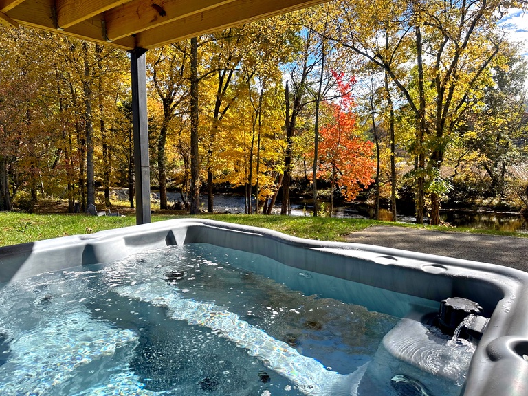 Relax in The Hot Tub at River Bank Retreat