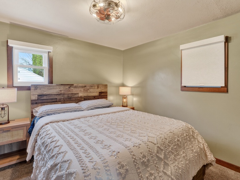 Bedroom 1- Queen bed. Relax in your peaceful bedroom with soft linens, rustic wood tones, and warm lighting that make unwinding effortless after a day of exploring.