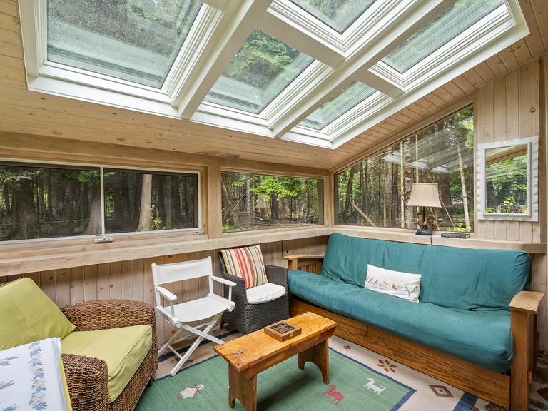 Guests will love the sunroom as an extra gathering space as well as the views