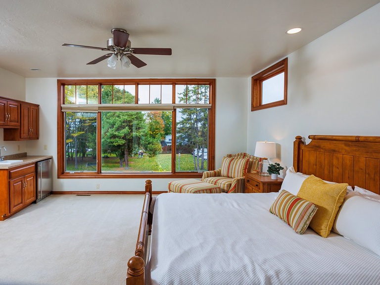 Primary bedroom not only offers space but a beautiful view