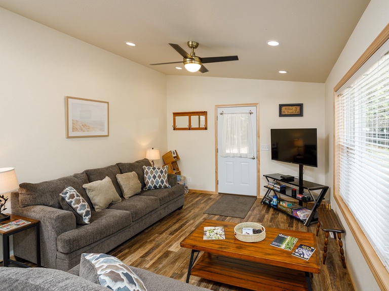 Living room includes Smart TV, DVD player, two couches (one pulls out to queen bed), coffee table, games & DVDs