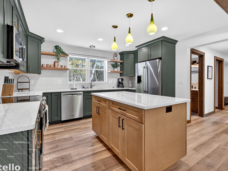 Your gourmet kitchen features modern appliances and elegant pendant lighting, perfect for preparing memorable meals during your stay.