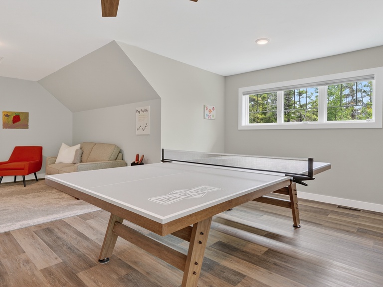 Step into your private game room, where laughter and friendly competition await. Challenge your companions to ping-pong under high vaulted ceilings, surrounded by natural light and modern comfort.
