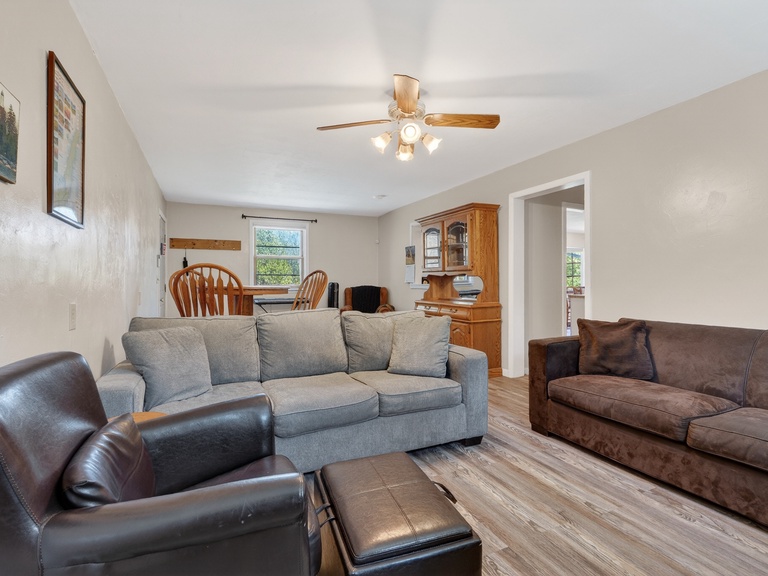 Adjacent to the kitchen is a sitting room, complete with TV, piano, and games for the family!