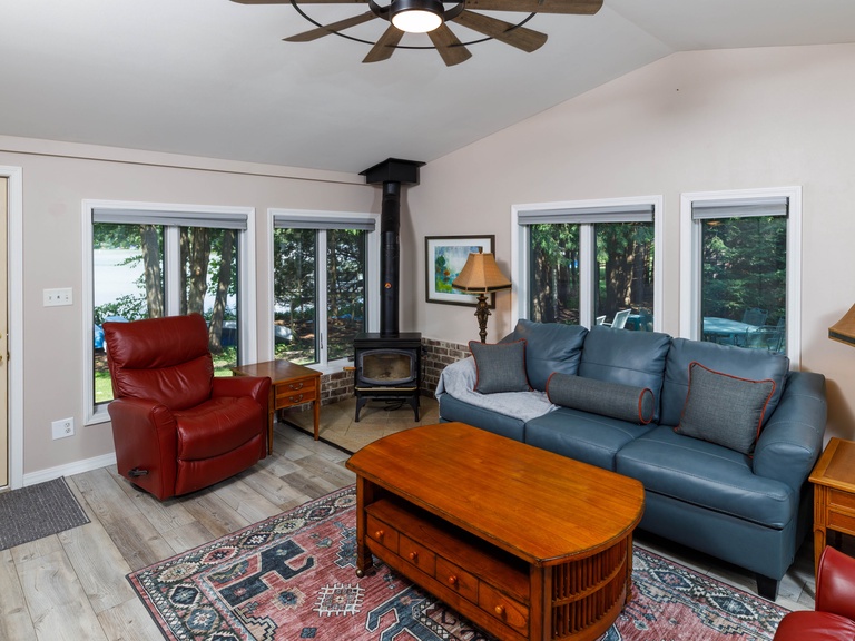 Living space includes plenty of seating options, a Smart TV and views of the lake