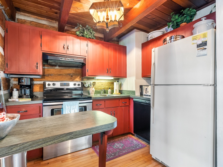 Cozy kitchen is well equipped including a coffee grinder and grill utensils