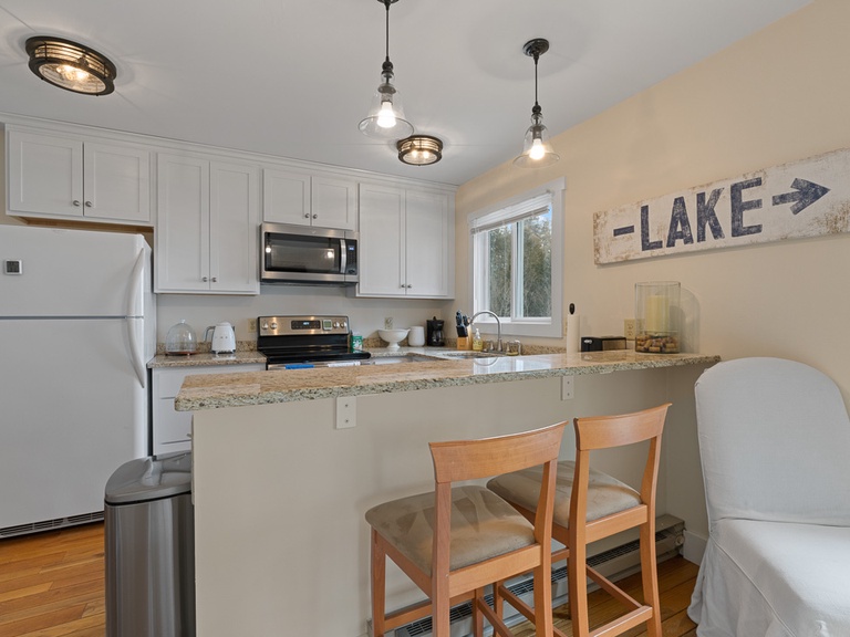 Fully stocked kitchen includes counter seating for 2