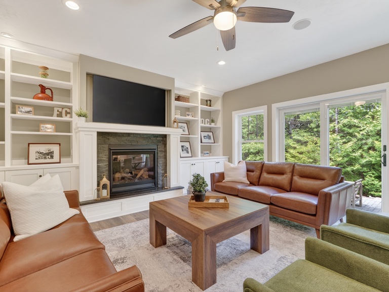 Sink into plush leather sofas and enjoy your favorite shows by the fireplace, with garden views framing your cozy retreat.