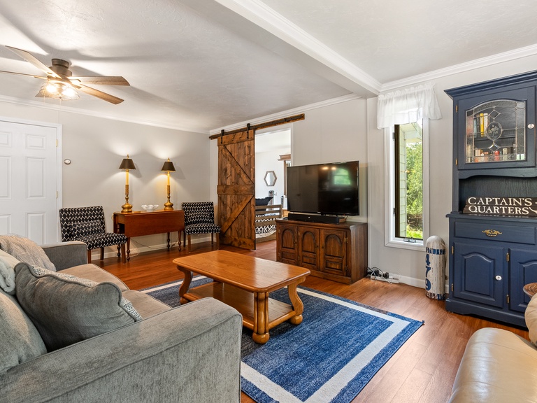 Main living area includes comfortable seating and a Smart TV