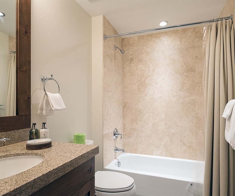 Shared Bathroom, Main Level - Hall bathroom adjacent to Bedroom 4 with single vanity and shower/tub combo