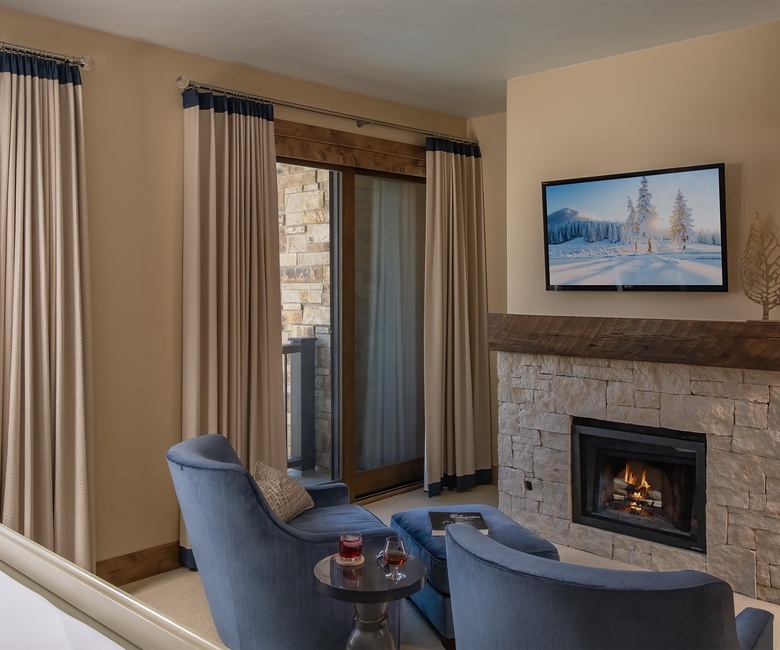 Bedroom 1, Main Level - Enjoy quiet mornings or evenings at the fireplace in the primary bedroom.