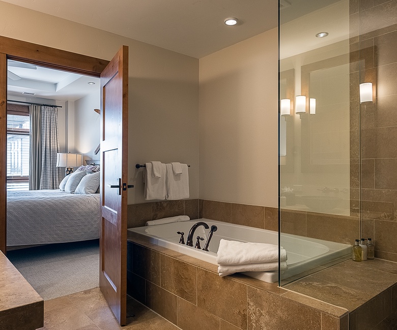 Bedroom 1, Main Level - Primary ensuite with soaking tub and walk-in shower
