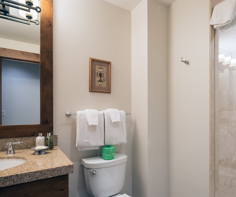 Step into your private spa-like retreat with gleaming granite counters, warm wood accents, and a spacious walk-in shower designed for total relaxation.