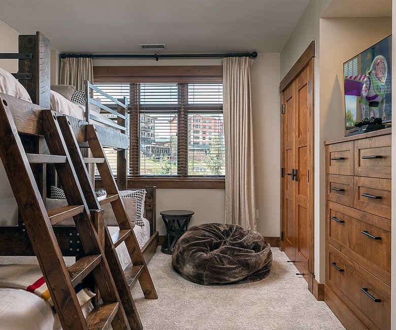 Your kids will love this fun bunk room with rustic wooden beds, a cozy bean bag, and entertainment ready to go. Perfect for making family vacation memories together.