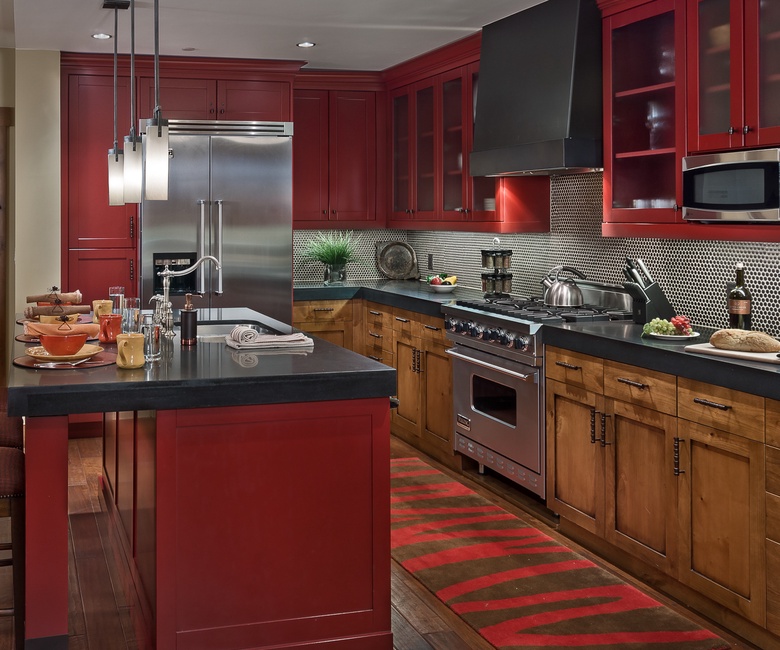 Kitchen, Main Level - With stainless steel appliances and bold red cabinetry