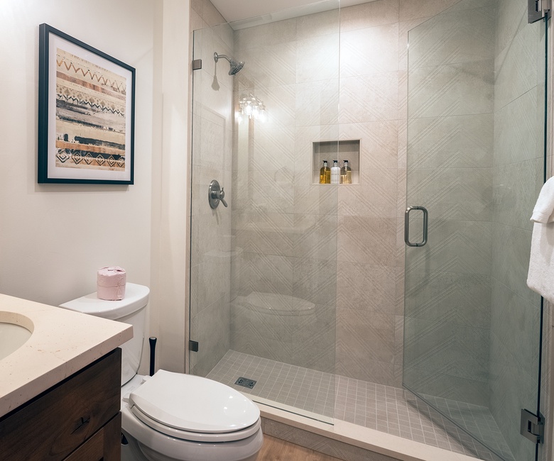 Shared Bathroom, Main Level - Hall bathroom adjacent to Bedroom 4 with single vanity and walk-in shower