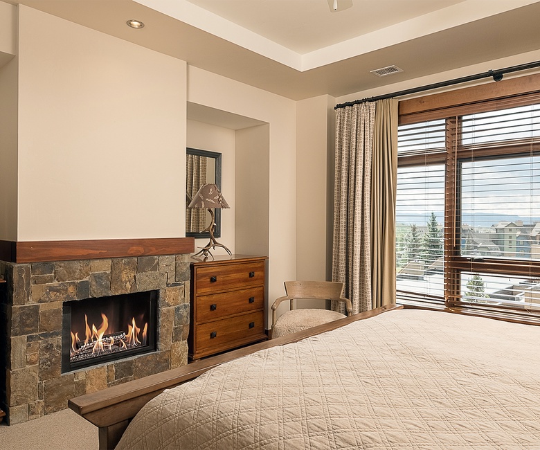 Bedroom 1, Main Level - Primary king bedroom with fireplace and mountain views