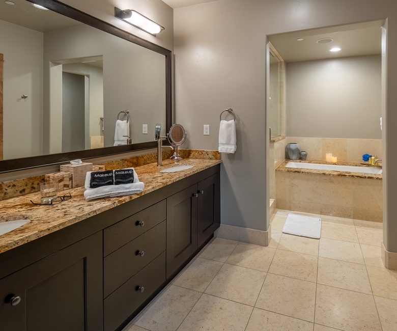Bedroom 1, Main Level - Primary king ensuite with spacious vanity and soaking tub