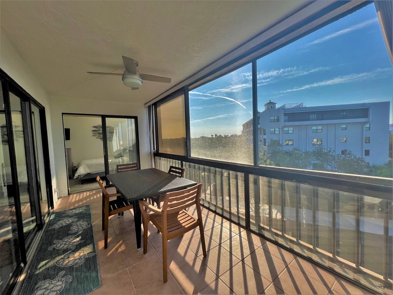 Step onto your private balcony for morning coffee with city views, complete with outdoor dining table and ceiling fan for comfort.
