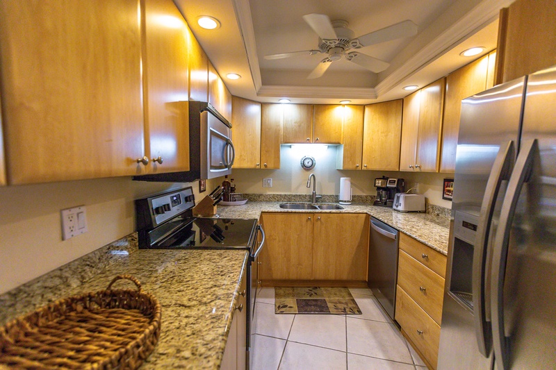 Your fully equipped kitchen welcomes you with granite countertops, stainless steel appliances, and warm wood cabinetry for effortless meal preparation.