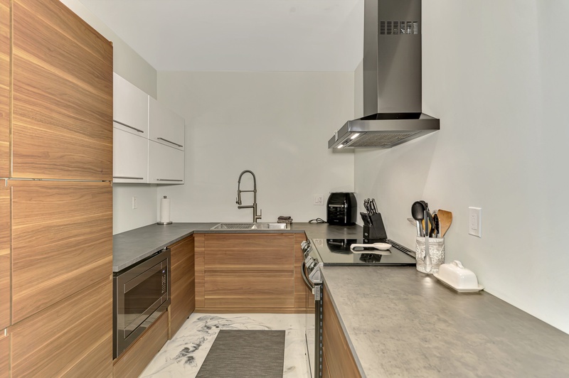 Step into your sleek modern kitchen with warm wood finishes, stainless steel appliances, and everything you need to create memorable meals.