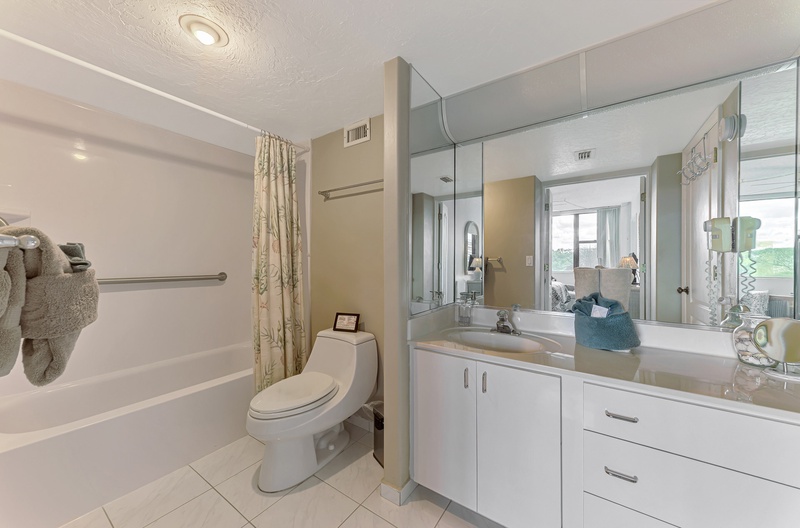 Your pristine bathroom features a spacious vanity, relaxing tub-shower combo, and thoughtful touches like plush towels for ultimate comfort.