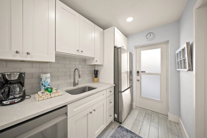 Your bright, modern kitchen features crisp white cabinets, stainless appliances, and everything you need for home-cooked meals.