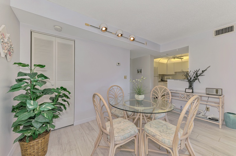 Your bright dining space features elegant glass-top seating for four, perfect for morning coffee or intimate meals together.