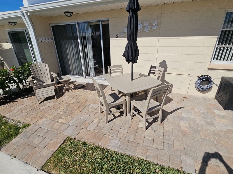 Your private patio with dining table and umbrella creates the perfect outdoor retreat for morning coffee or evening meals.