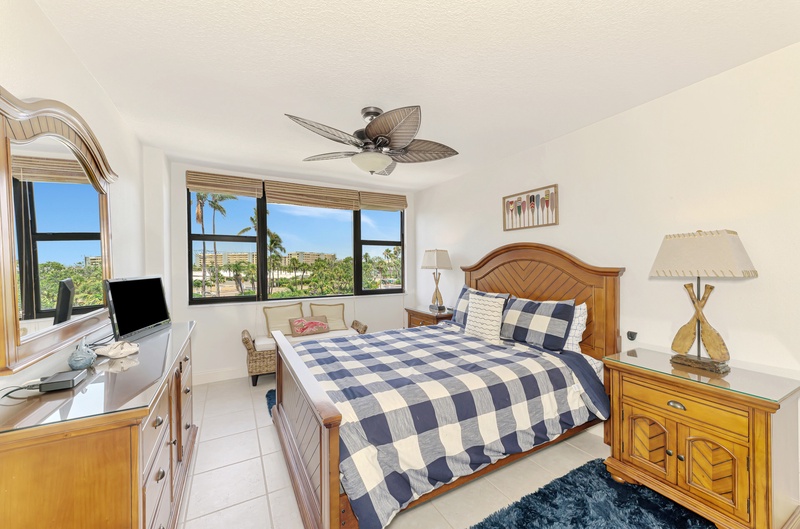 Wake up to tropical palm views from your cozy bedroom with comfortable furnishings and refreshing ceiling fan breeze.