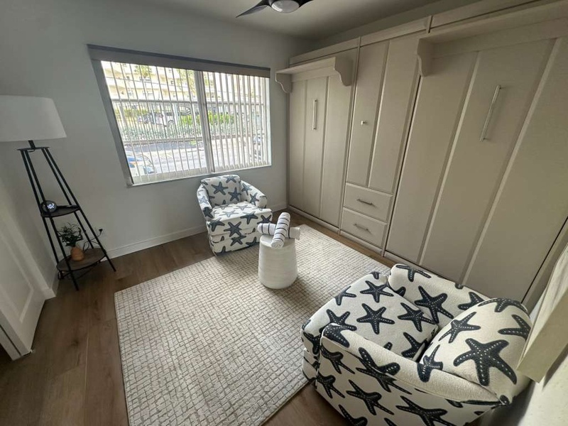 Relax in your bright seating area with coastal starfish-themed chairs and ample wardrobe storage for all your vacation essentials.