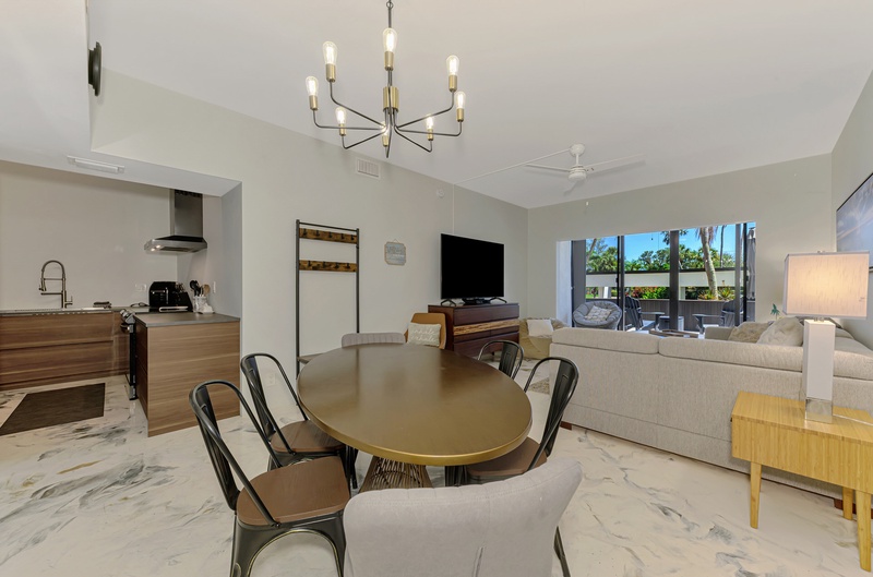 Your spacious open-plan living area flows seamlessly from kitchen to dining, perfect for gathering with loved ones under elegant lighting.