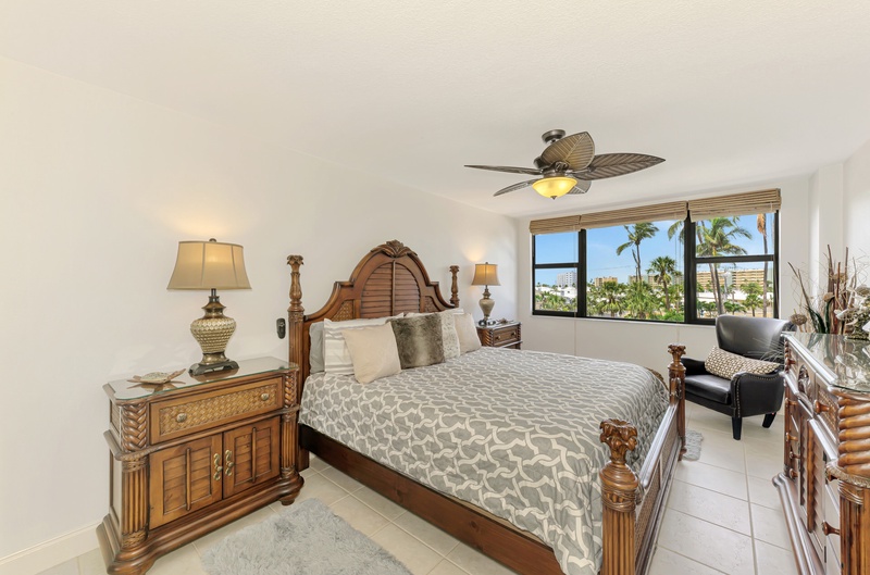 Sink into tropical luxury with elegant wooden furnishings and palm tree views from your private retreat.